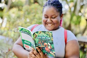 Girl Reading and smiling